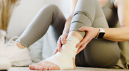 Fit female with an injured ankle thats wrapped and compressed