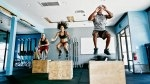 Group fitness class working out with box jumps exercises and Plyometric exercises