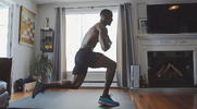 Strong and fit black man performing plyometric training exercises with an at-home plyometric workout