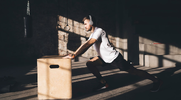 Fit man stretching before his begins his plyometric training session