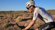 Cyclist Colin O’Brady cooling himself off with a splash of water in the hot desert heat