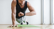 Man performing planks for his High lactate training plan with time under tension