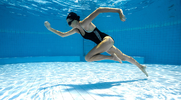 Woman running underwater as part of her pool workouts