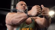 Phil Heath working out with a cable cross over machine