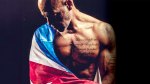 Actor Roberto Sanchez wrapped in the American Flag and showing his muscular physique