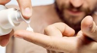 Man applying lotion to his finger